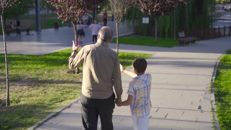 Grandfather-and-grandchild-walking-outdoors.